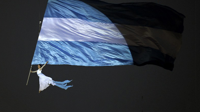 An acrobat performs at Plaza de Mayo square in Buenos Aires on May 25, 2013. (AFP Photo / Alejandro Pagni)