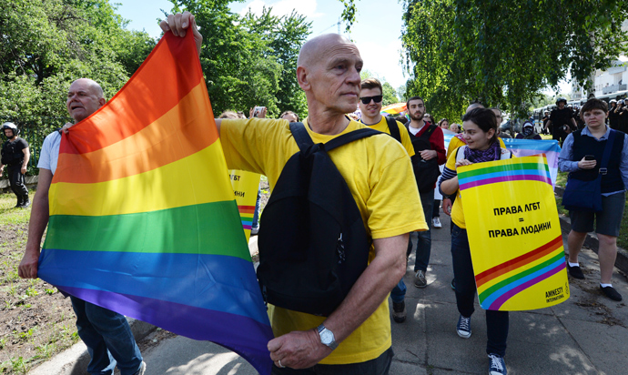 Activists carry a rainbow flag during a Gay Parade in Kiev on May 25, 2013 (AFP Photo / Sergey Supinsky)