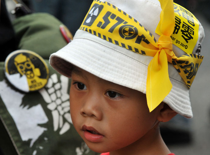 A little boy wearing hat with a yellow protest sign is seen at a demonstration against Taiwan's controversial fourth nuclear power plant at a gathering in Taipei on May 26, 2013 .(AFP Photo / Mandy Cheng)