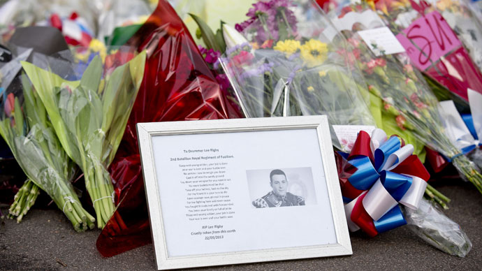 A framed photograph of Drummer Lee Rigby lies amongst floral tributes outside Woolwich Barracks in London on May 23, 2013.(AFP Photo / Justin Tallis)