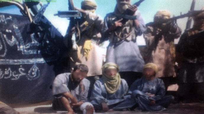 A picture taken from a video shown to an AFP correspondent on December 12, 2011 shows two Spaniards and an Italian kidnapped in Algeria in October and purportedly held by an Al-Qaeda splinter group. (AFP Photo / Serge Daniel)