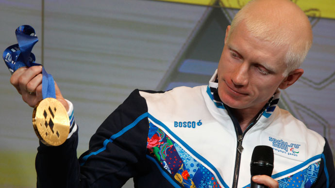 Russian athlete and the London 2012 Paralympic Games champion in the Men's 100m T12 event Fedor Trikolich presents the gold medal for the 2014 Winter Paralympic Games in Sochi during a ceremony in St. Petersburg May 30, 2013.(Reuters / Alexander Demianchuk)