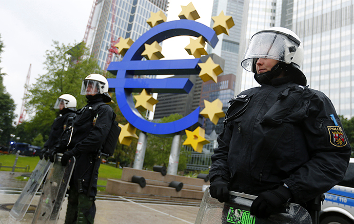 Riot police stand near the euro sign in front of the European Central Bank (ECB) headquarters during an anti-capitalist "Blockupy" demonstration in Frankfurt May 31, 2013. (Reuters / Kai Pfaffenbach)