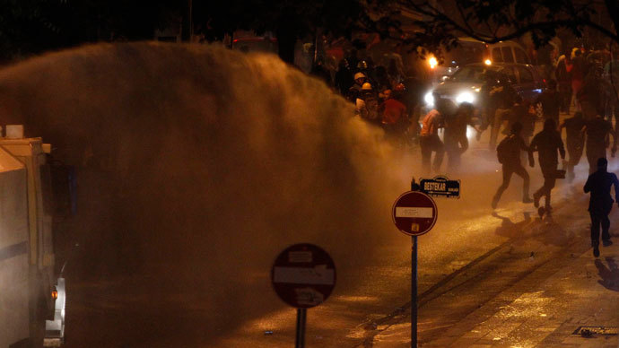 Protesters run away from a riot police water cannon during a demonstration in Kennedy street in central Ankara, June 15, 2013. (Reuters / Dado Ruvic)