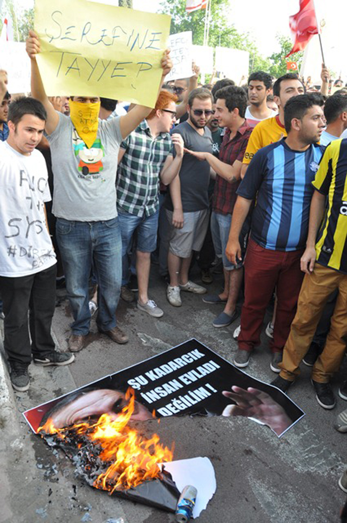 Protesters burn the image of Turkish PM Recep Tayyip Erdogan at the 'Solidarity with people in Turkey and Taksim Squareâ demonstration in Nicosia, Cyprus / Photo by Melis Tutan