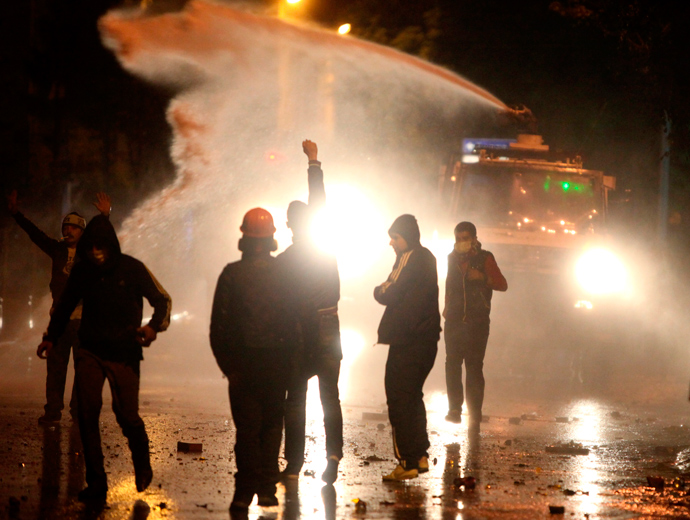 Riot police use a water cannon against anti-government protesters as others run away during a demonstration in central Ankara, June 9, 2013 (Reuters / Dado Ruvic)