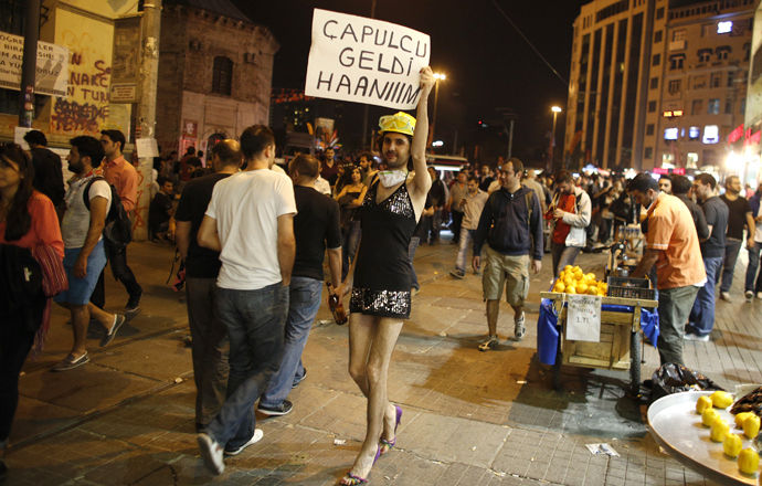 A gay rights activist holds a sign as he protests near Taksim Square in Istanbul June 7, 2013. The sign reads, "The looter is coming, ladies" (Reuters / Stoyan Nenov)