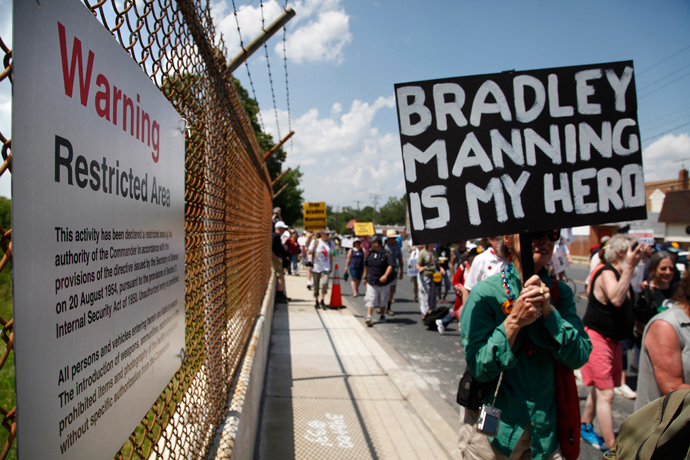 Protesters march past a 'Restricted Area' sign as they rally to call for the release of jailed U.S. Army Private Bradley Manning, a central figure in the Wikileaks case, outside the fence at Fort Meade, Maryland, June 1, 2013 (Reuters / Jonathan Ernst)