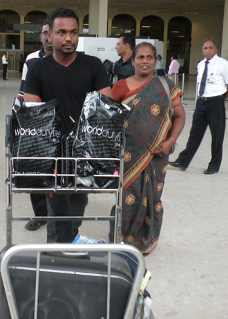 Failed Sri Lankan asylum seekers deported from Britain exit the airport following their arrival in Colombo (AFP Photo / STR)