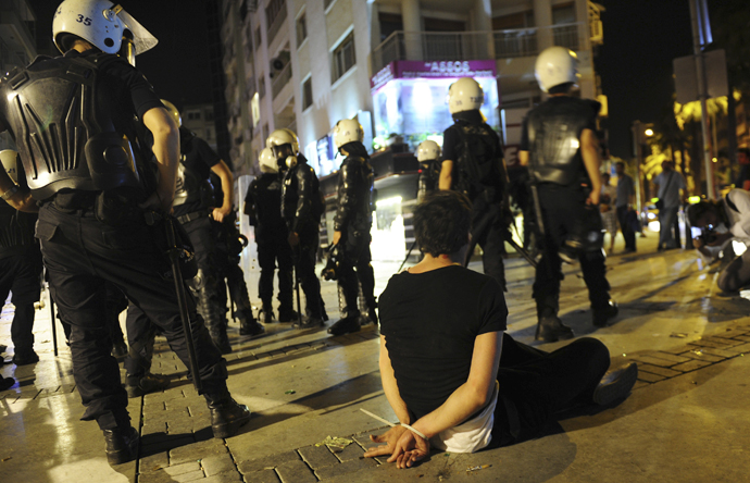 A demonstrator sits on the ground after he was detained by riot police during an anti-government protest in Izmir, western Turkey, June 2, 2013. (Reuters)