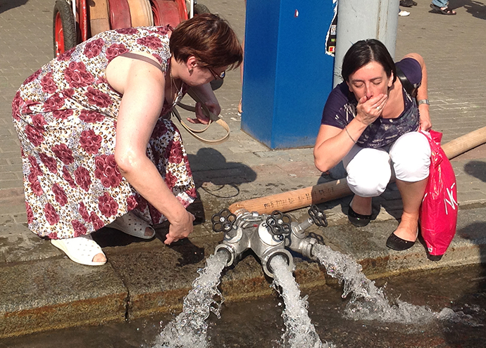 Women wash soot off their faces near the Okhotny Ryad subway station closed due to a fire. (RIA Novosti / Marina Batasheva)