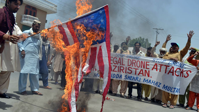 Pakistani protesters from the United Citizen Action torch a US flag as they shout slogans during a protest in Multan on May 30, 2013.(AFP Photo / S.S Mirza)