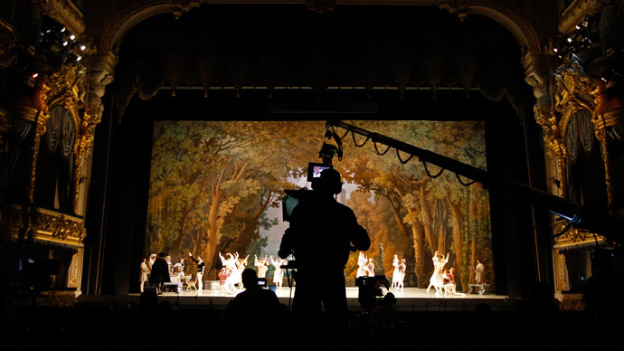 A cameraman films members of the Mariinsky theatre performing during a rehearsal for filming in St.Petersburg June 2, 2013.(Reuters / Alexander Demianchuk)