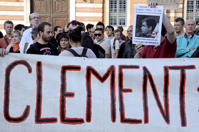 A demonstrator holds up a poster reading, "Clement Meric, 18 years old, forever in our hearts, neither forget, nor forgive" during a demonstration on June 6, 2013. (AFP Photo / Pascal Pavani)