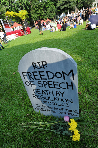 A mock tombstone is displayed during a rally at a free-speech park called Speakers' Corner in Singapore on June 8, 2013 (AFP Photo / Roslan Rahman) 