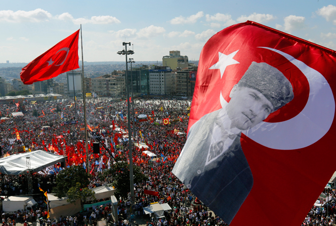 An anti-government protester waves a Turkish flag depicting the founder of modern Turkey Mustafa Kemal Ataturk as thousands of protesters gather in Istanbul's Taksim square June 9, 2013 (Reuters / Yannis Behrakis)