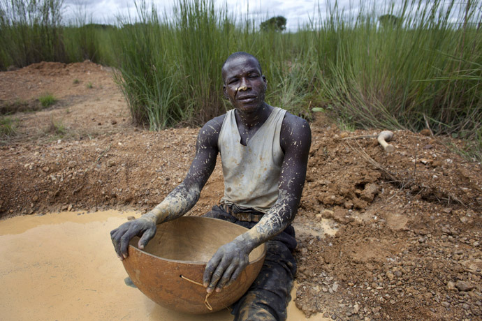 Artisanal gold miner Mamadou Diarra poses for a picture in between panning for gold at a small scale mine in Kalana (Reuters)