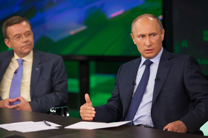 Russian President Vladimir Putin, center, during his talk with Russia Today television channel's journalists and correspondents, June 11, 2013. (RT photo / Semyon Khorunzhy)