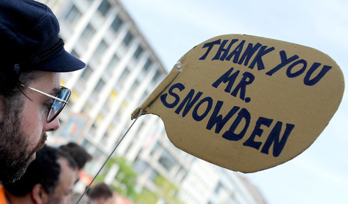 A demonstrator holds up a placard in support of former US agent of the National Security Agency, Edward Snowden as they take part in a protest against the US National Security Agency (NSA) collecting German emails, online chats and phone calls and sharing some of it with the country's intelligence services in Hanover, northern Germany on July 27, 2013. (AFP/DPA)