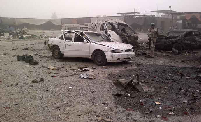 A member of Iraq security personnel inspects the site of a car bomb attack at Jadidat al-Shatt in Diyala province, 40 km (25 miles) north of Baghdad, June 10, 2013. (Reuters)