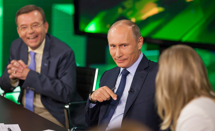 Russian President Vladimir Putin, center, during his talk with Russia Today television channel's journalists and correspondents, June 11, 2013. (RT photo / Semyon Khorunzhy)