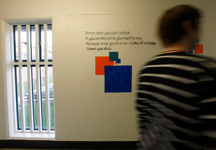 A prisoner passes poetry written on a wall in Doncaster Prison, northern England (Reuters / Darren Staples)