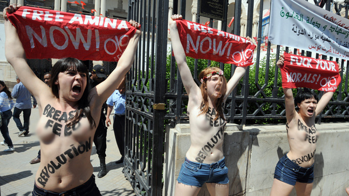  A file picture taken on May 29, 2013 shows three activists from the women's movement Femen demonstrating in front of the justice Palace in Tunis, before being arrested. The three women, two French and one German, face jail terms of up to a year when they go on trial in Tunis on June 5, although their lawyer is confident of a lighter sentence (AFP Photo / Fethi Belaid)