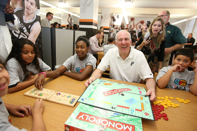 Head Coach Gregg Popovich of the San Antonio Spurs interacts with the kids at the 2013 NBA Cares Legacy Project as part of the 2013 NBA Finals on June 7, 2013 at the Wheatley Middle School in San Antonio, Texas (NBAE Nathaniel S. Butler / NBAE via Getty Images / AFP) 