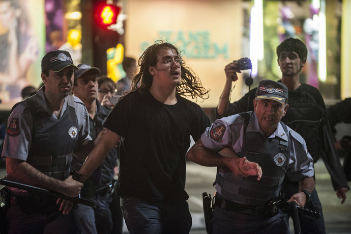 A demonstrator is arrested during a protest against the rise in public bus and subway fare from 3 reais to 3.20 reais (1.50 USD) in Sao Paulo, Brazil, on June 11, 2013. (AFP Photo/Nelson Almeida)