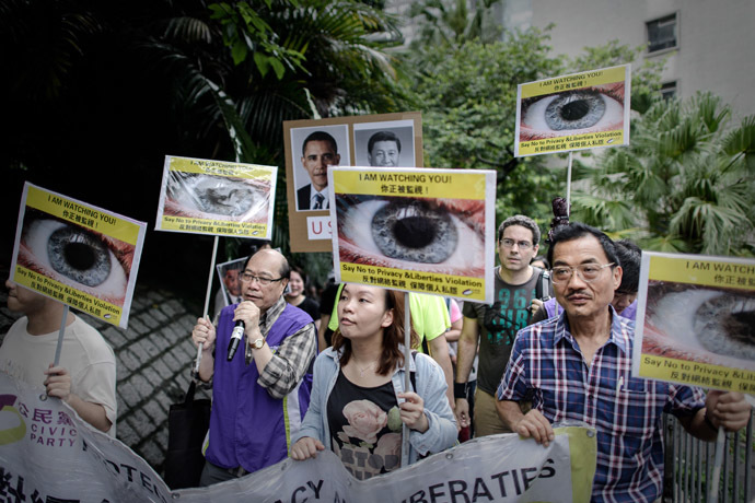 Protesters hold placards as they march to the US consulate in support of Edward Snowden from the US in Hong Kong on June 15, 2013. (AFP Photo/Philippe Lopez)