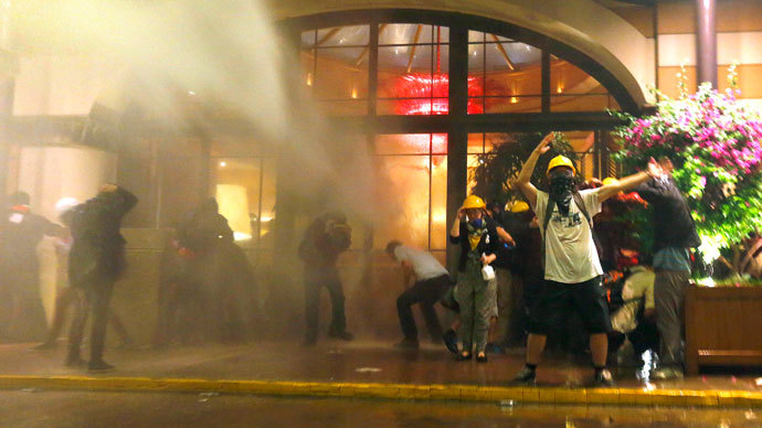 Protesters are attacked by police water cannon and tear gas in front of a hotel where they took shelter next to Gezi Park near Istanbul's Taksim square June 15, 2013.(Reuters / Yannis Behrakis )