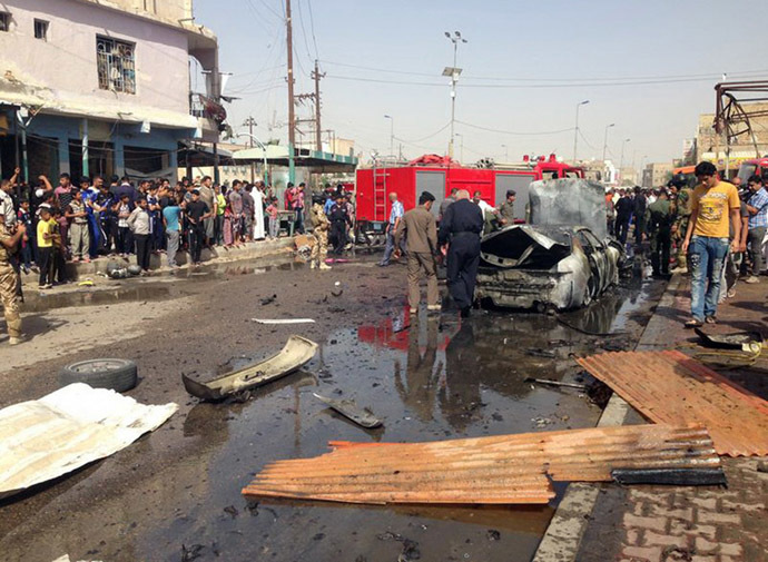 Iraqis gather at the scene of an explosion in Nasiriyah, south of the Iraqi capital Baghdad on June 16, 2013. (AFP Photo/Amer Karim)