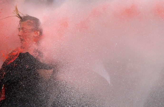 A woman is attacked by water cannon during protests in Kizilay square in central Ankara, June 16, 2013. (Reuters)
