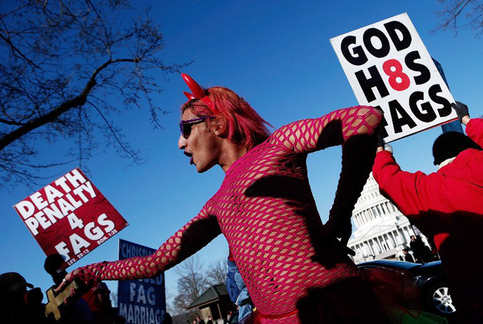 New York based drag performer Qween Amor dances during a rally while surrounded by protesters from the conservative Westboro Baptist Church in front of the U.S. Supreme Court in Washington, DC. (AFP Photo / Win Mcnamee)
