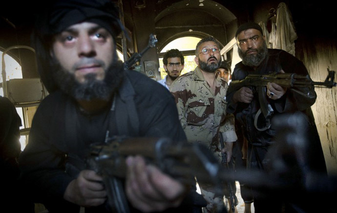 Syrian rebels take position in a house during clashes with regime forces in the old city of Aleppo. (AFP Photo / Ricardo Garcia Vilanova)