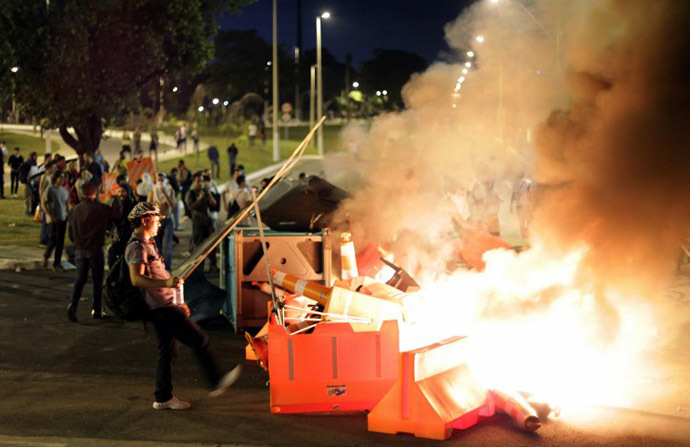 Demonstrators set fire to traffic signs during a protest at the Antonio Carlos Avenue, next to Mineirao stadium which hosts the Confederations Cup, on June 17, 2013. (AFP Photo / Bernardo Salce)