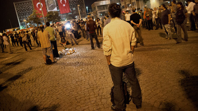 Turkish choreographer Erdem Gunduz (C) stands on Taksim square following what had been a lone protest June 18, 2013.(AFP Photo / Marco Longari)