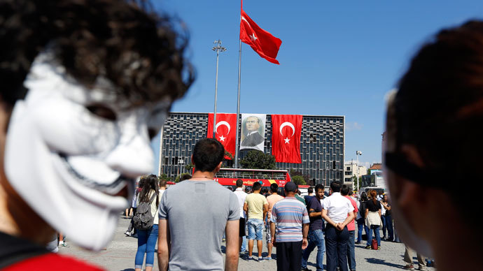 A protester wearing a Guy Fawkes mask stands along with others during a silent protest at Taksim Square in Istanbul June 18, 2013.(Reuters / Marko Djurica)