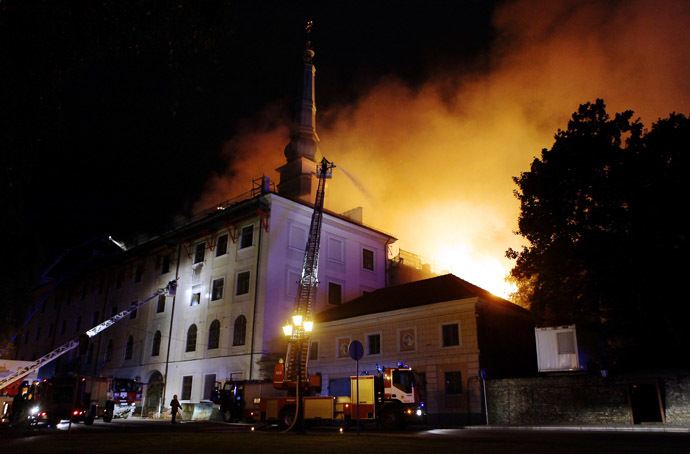 Firefighters put out a fire burning at Riga Castle in Riga on June 20, 2013. (AFP Photo)