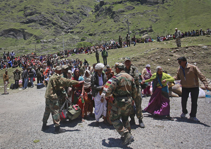 Soldiers stop survivors from going near an army helicopter as its lands during rescue operations at Badrinath in the Himalayan state of Uttarakhand June 21, 2013 (Reuters/Danish Siddiqu)