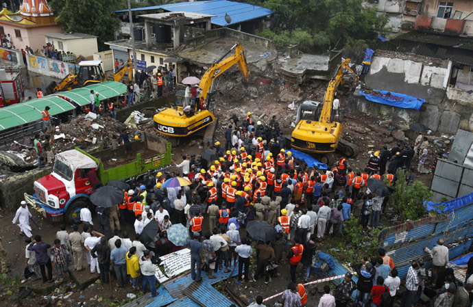 Rescue workers use excavators to scour the debris for survivors at the site of a collapsed residential building in Mumbra, in Thane district, on the outskirts of Mumbai June 21, 2013 (Reuters/Vivek Prakash)