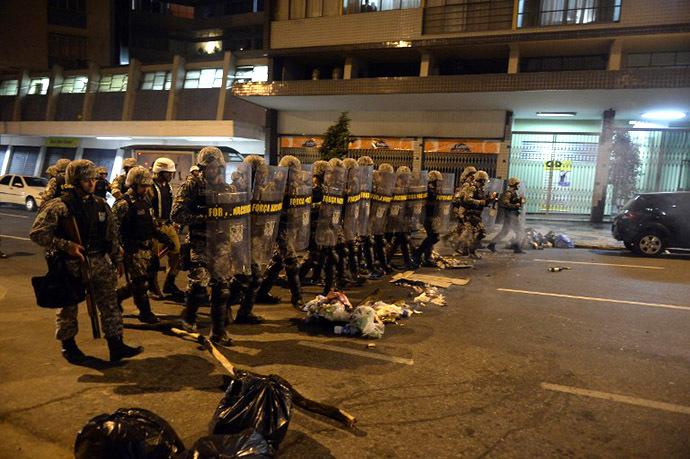  Policemen move into position in the street during a protest against corruption and price hikes in Belo Horizonte, Brazil on June 22, 2013. (AFP Photo / Yuri Cortez)
