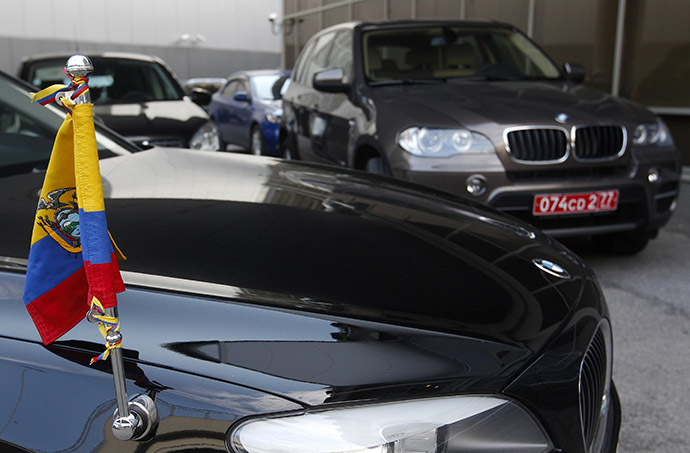 Two cars of the embassy of Ecuador in Moscow are parked outside the terminal where Edward Snowden, the former contractor for the U.S. National Security Agency, is believed to have landed in Moscow's Sheremetyevo airport, June 23, 2013. (Reuters / Maxim Shemetov)