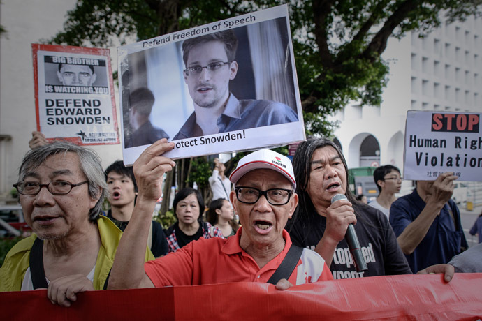 In this file picture taken on June 13, 2013 protesters shout slogans in support of former US spy Edward Snowden as they march to the US consulate in Hong Kong. (AFP Photo)