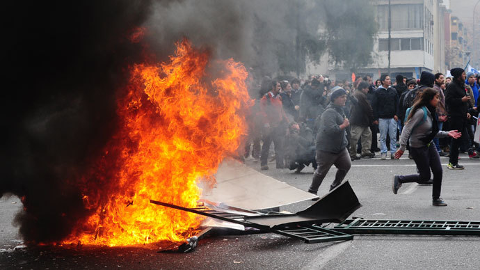 Students clash with riot police during a protest to demand Chilean President Sebastian Pinera's government to improve the public education quality, in Santiago, on June 26, 2013.(AFP Photo / Martin Bernetti)