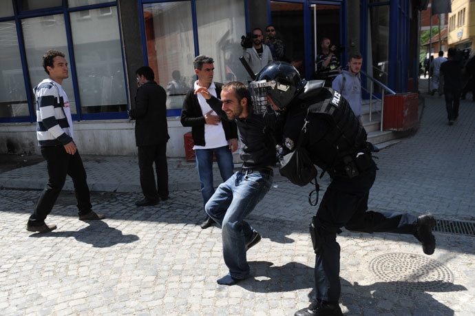 Kosovo Police detain a demonstrator following clashes in Pristina on June 27, 2013.(AFP Photo / Armend Nimani)