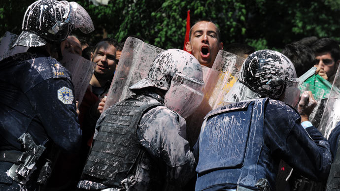 Kosovo Police splashed with paint clash with demonstrators in Pristina on June 27, 2013.(AFP Photo / Armend Nimani)