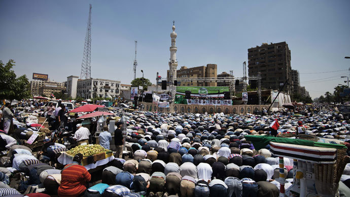 Thousands of Islamists and Muslim Brotherhood supporters perform the Friday prayers as they gather at Rabaa al-Adawiya mosque to start an open-ended sit-in in support of the legitimacy of President Mohamed Morsi in Cairo on June 28, 2013.(AFP Photo / Gianluigi Guercia)