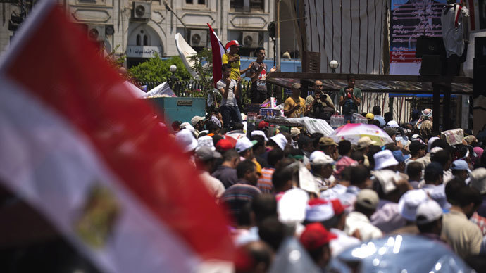 Islamists and Muslim Brotherhood supporters perform Friday prayers at Rabaa El-Adaweya mosque as thousands gather to start an open-ended sit in to show their support for the legitimacy of Egyptian President Mohammed Morsi on June 28, 2013 in the capital Cairo.(AFP Photo / Gianluigi Guercia)