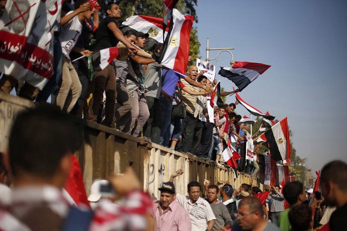 Protesters opposing Egyptian President Mohamed Morsi waves Egyptian flags during a protest in front of the presidential palace in Cairo June 30, 2013. (Reuters/Suhaib Salem)